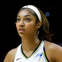 Angel Reese stands on the basketball court